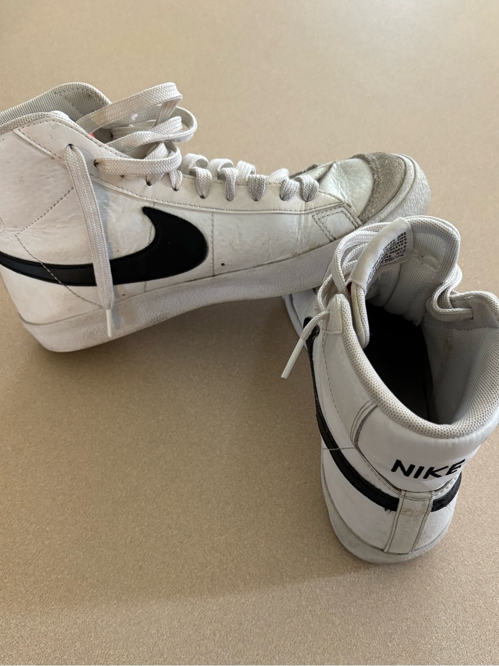 Nike Women’s White and Black High-Top Sneakers with Iconic Swoosh
